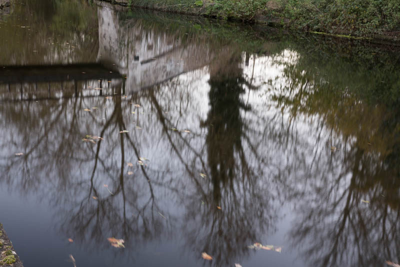 Reflection of bridge in the canal it's crossing